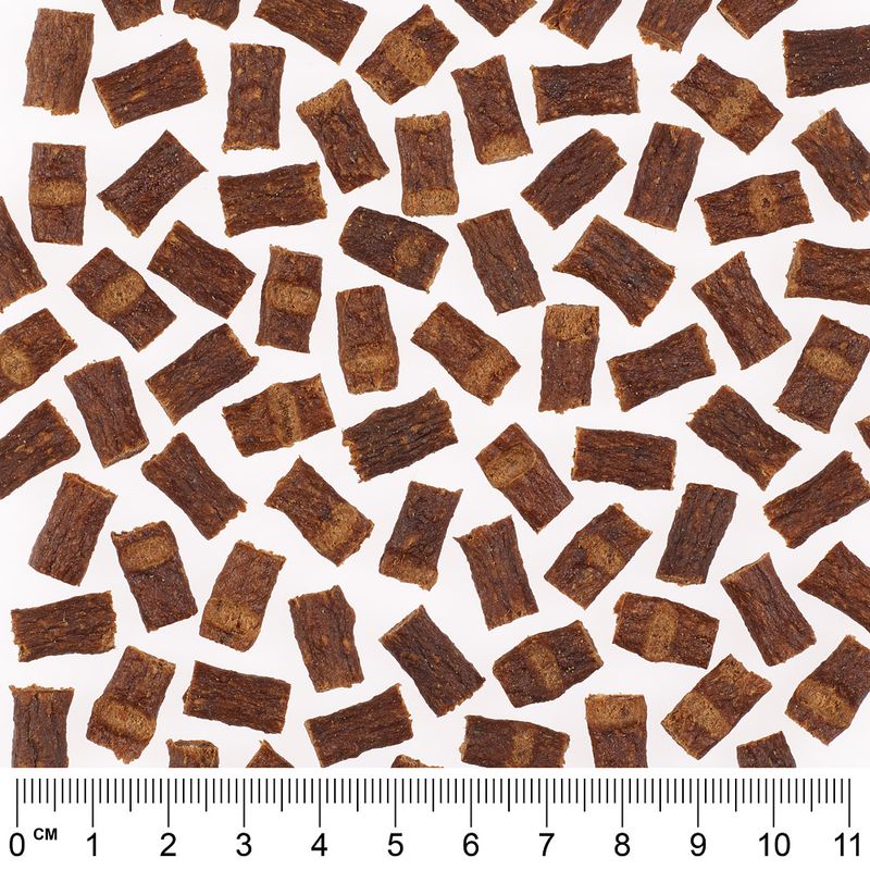 Close-up of brown snack pieces with centimetre scale, showing size and shape of the pieces.
