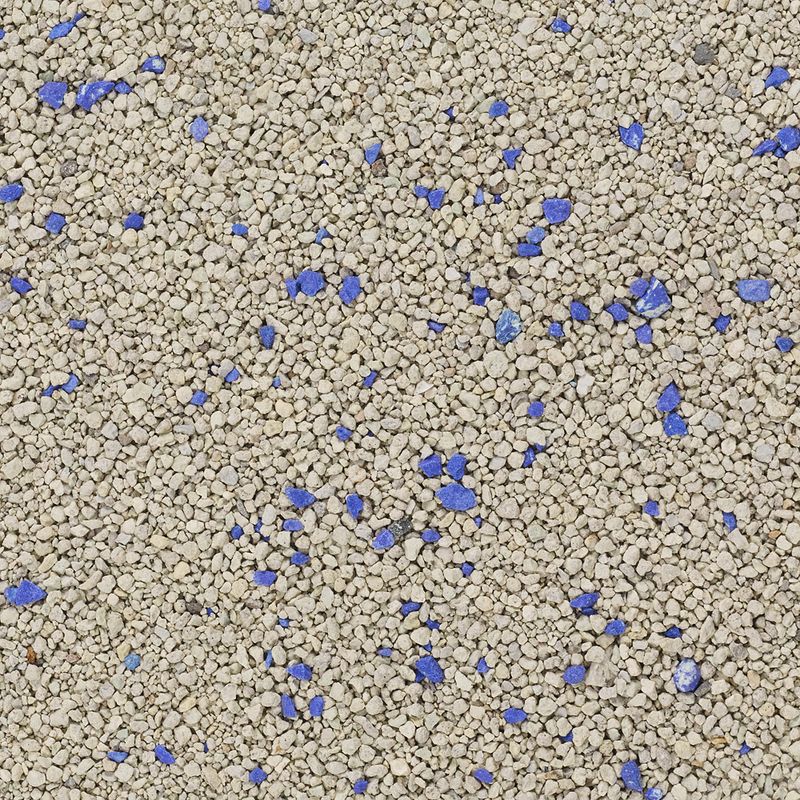 Close-up of cat litter with grey granules and blue particles.